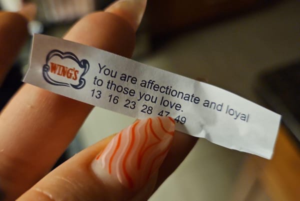 A close up image of a fortune cookie slip that reads "You are affectionate and loyal to those you love."